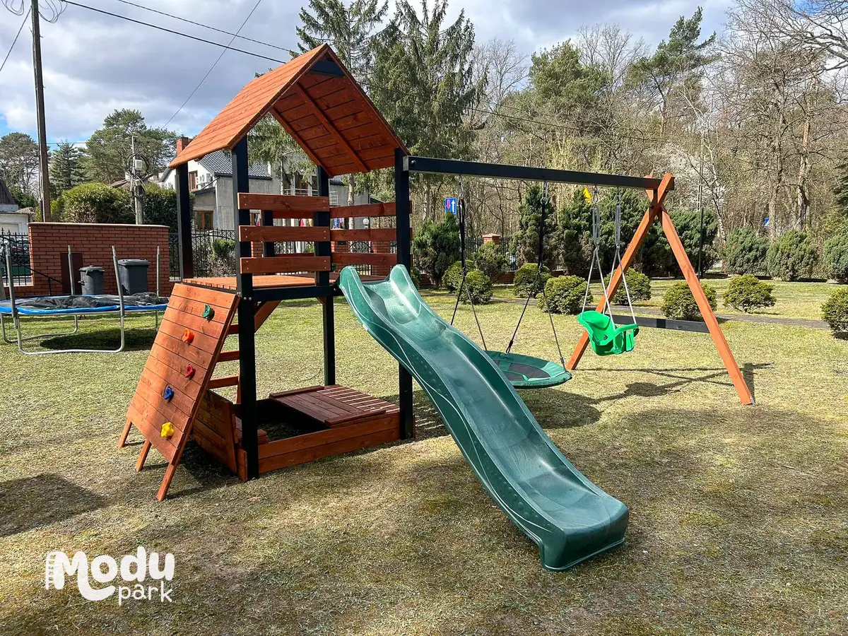 Drewniany domek ze zjeżdżalnią i huśtawką do ogrodu — wieża Pinokio ModuPark z zadaszeniem, ślizgiem i huśtawką na trawniku